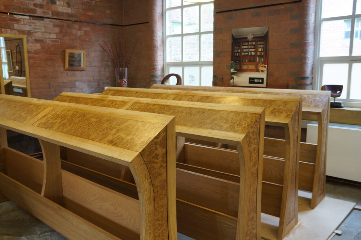 View of choir stalls in oak for Wakefield Cathedral ready for oiling
