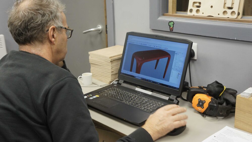 Furniture designer working on CAD CAM organic wooden furniture