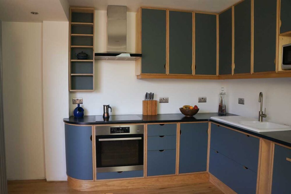 Lino and plywood kitchen by Dovetailors - bespoke under the sink drawers