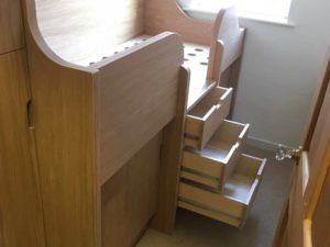 fitted look Small-bedrooms-cabin-bed-with-pull-out-desk - drawers are fitted in the stairs